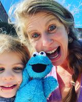 jill eickman and daughter posing with cookie monster