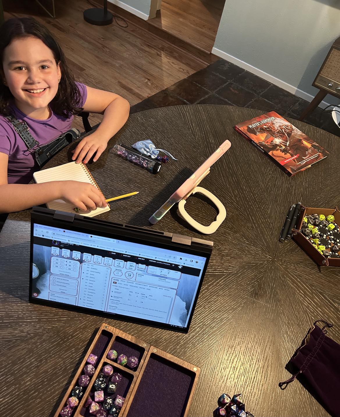 girl smiling as she sets the table up to play the game dungeons and dragons